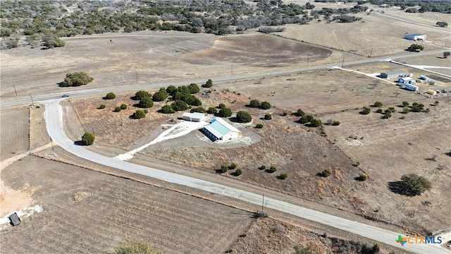 birds eye view of property with a rural view