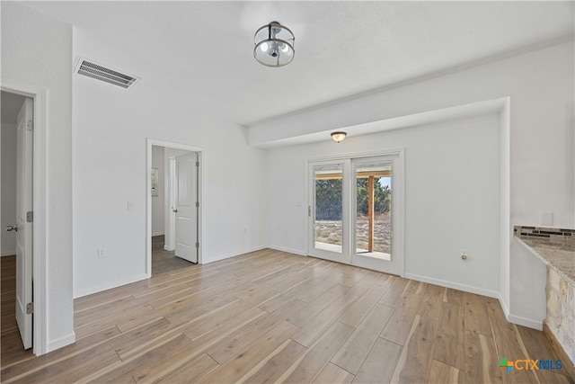 unfurnished living room with light wood-type flooring