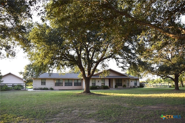 single story home featuring a front lawn