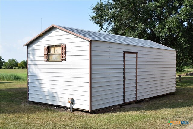 view of outbuilding featuring a lawn