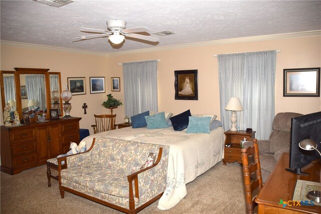 carpeted bedroom featuring ceiling fan, a textured ceiling, and ornamental molding