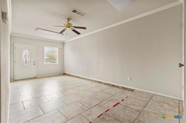 tiled spare room featuring ceiling fan and ornamental molding