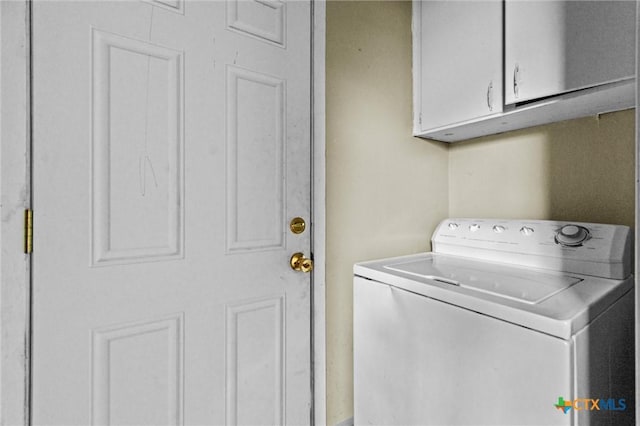 washroom featuring cabinets and washer / dryer