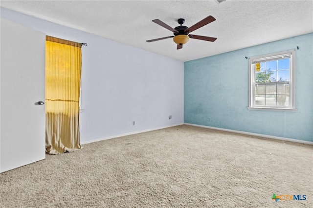 spare room featuring ceiling fan, carpet floors, and a textured ceiling