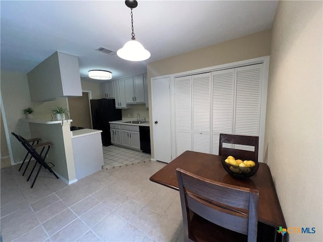 2007 Castle Gate Cir, San Marcos, TX 78666 - kitchen featuring freestanding refrigerator, light countertops, pendant lighting, and a peninsula