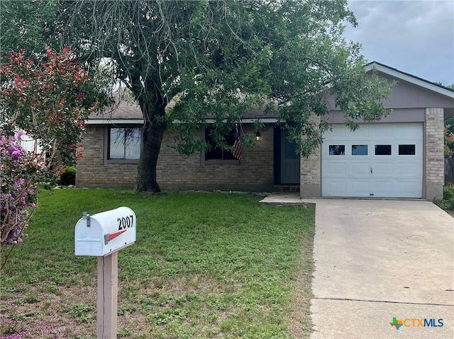 2007 Castle Gate Cir, San Marcos, TX 78666 - view of front of property with brick siding, an attached garage, concrete driveway, and a front yard