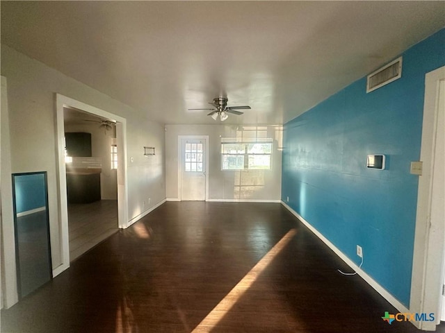 empty room featuring dark hardwood / wood-style flooring and ceiling fan