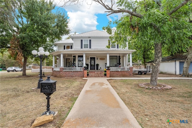 view of front of property featuring a front lawn and a porch