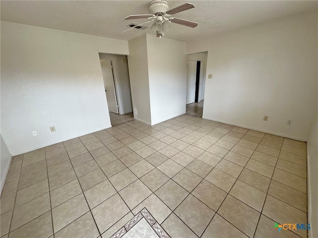 unfurnished room with baseboards, a textured ceiling, visible vents, and a ceiling fan