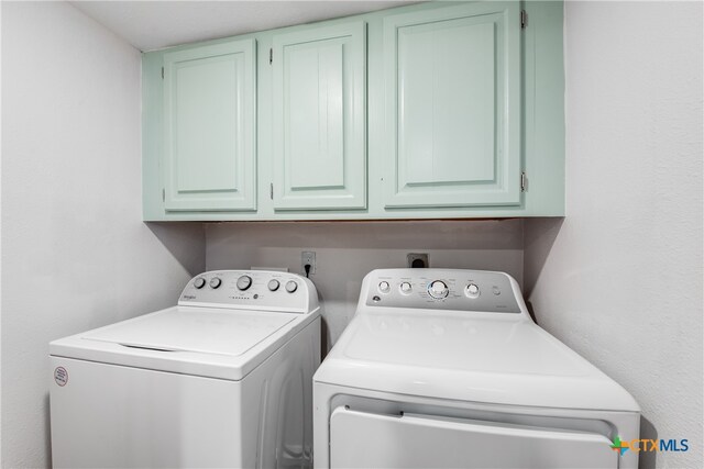 washroom with cabinets and independent washer and dryer