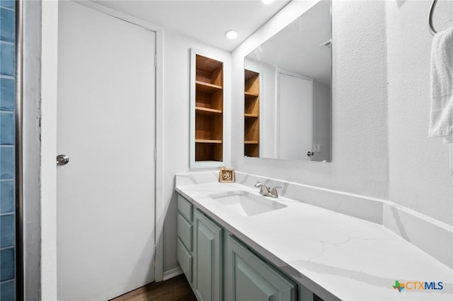 5973 State Highway 361 Unit 125, Port Aransas, TX 78373 - bathroom featuring vanity, wood finished floors, and recessed lighting