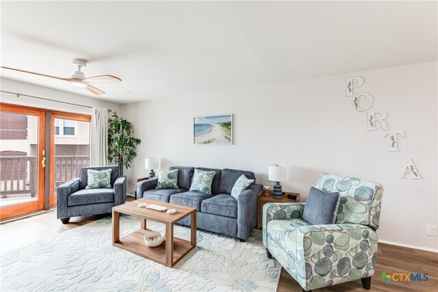 living room featuring light hardwood / wood-style floors and ceiling fan