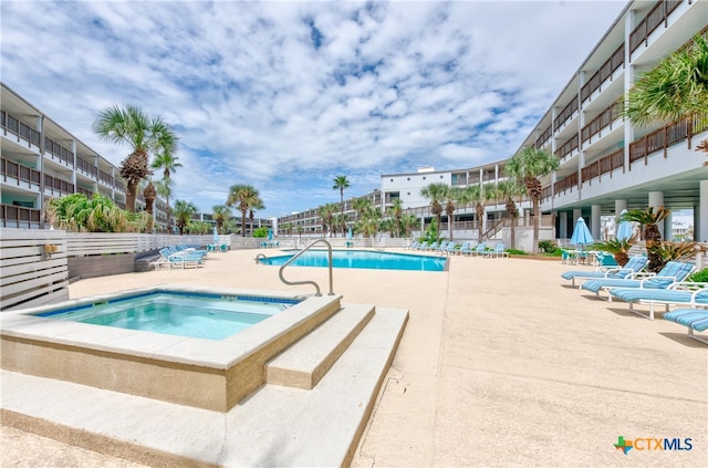 view of pool with a patio and a community hot tub