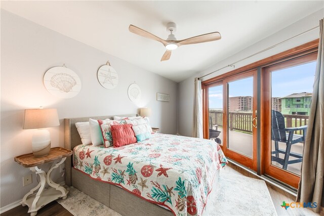 bedroom with ceiling fan, wood-type flooring, access to exterior, and lofted ceiling