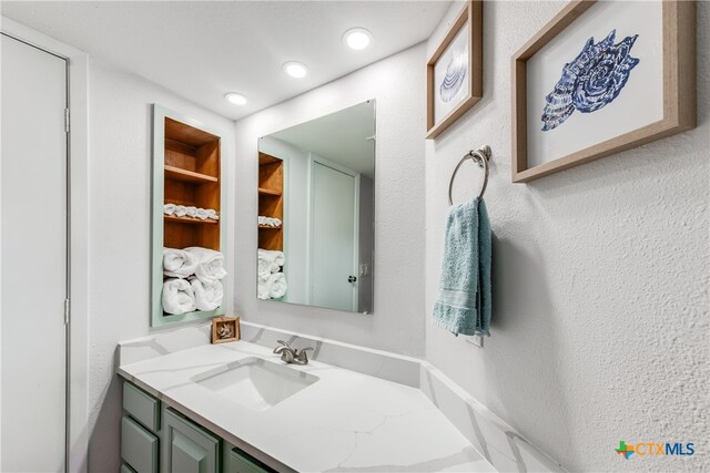 bathroom with built in features and vanity