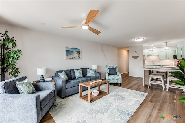 living room with hardwood / wood-style flooring and ceiling fan