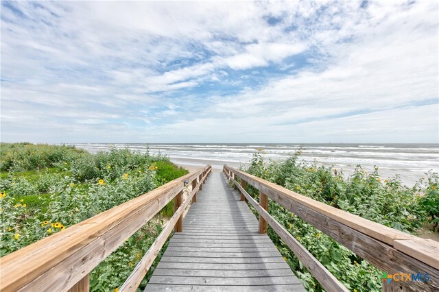 view of community featuring a beach view and a water view