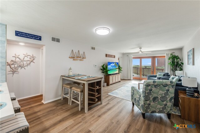 living room featuring ceiling fan and wood-type flooring