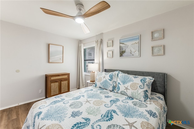 bedroom featuring ceiling fan and dark hardwood / wood-style floors