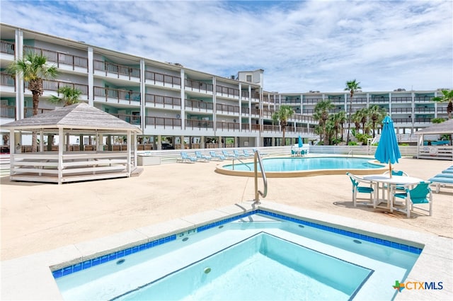 view of swimming pool with a patio area and a gazebo