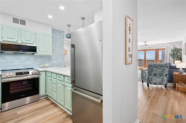 5973 State Highway 361 Unit 125, Port Aransas, TX 78373 - kitchen featuring appliances with stainless steel finishes, decorative backsplash, light wood finished floors, light countertops, and a ceiling fan