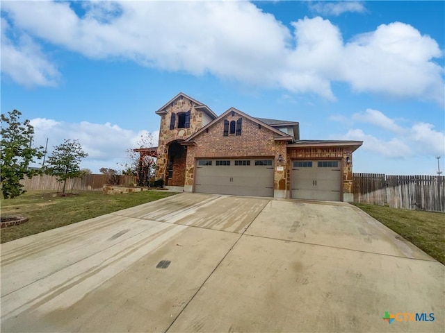 view of front of home with a garage and a front lawn