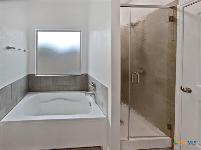 bathroom with shower with separate bathtub