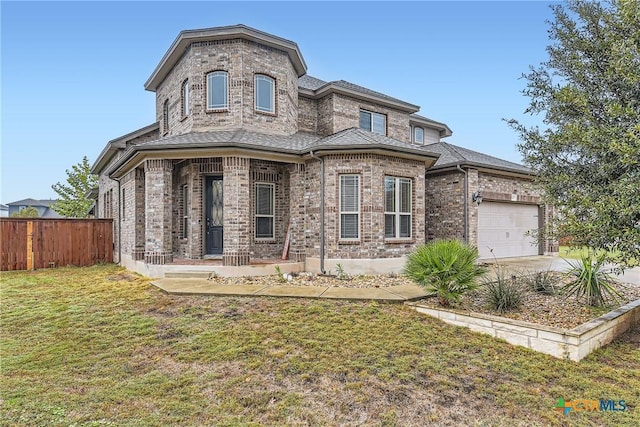 view of front of home with a garage and a front lawn