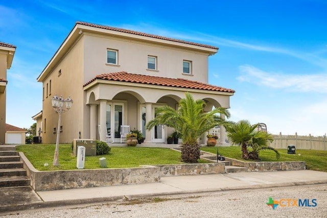 3 Sago Dr, Port Lavaca, TX 77979 - mediterranean / spanish-style house featuring stucco siding, a tiled roof, covered porch, and central AC