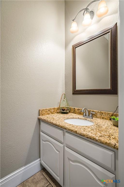 3 Sago Dr, Port Lavaca, TX 77979 - bathroom with vanity, baseboards, and a textured wall