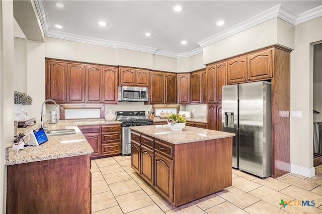 3 Sago Dr, Port Lavaca, TX 77979 - kitchen featuring stainless steel appliances, a sink, light tile patterned floors, a center island, and light stone countertops