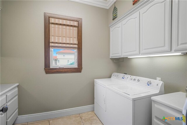 3 Sago Dr, Port Lavaca, TX 77979 - laundry room featuring washing machine and clothes dryer, cabinet space, baseboards, crown molding, and light tile patterned floors