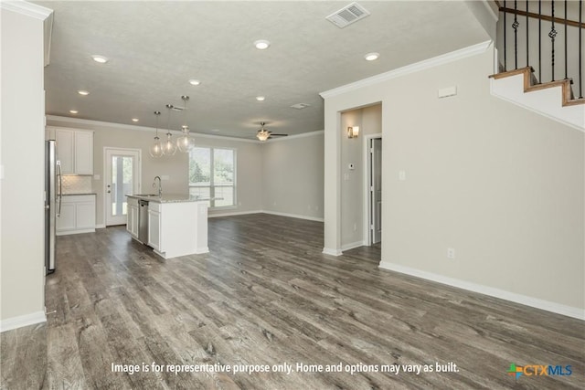 7100 Mcgregor Loop, Killeen, TX 76549 - unfurnished living room with ornamental molding, recessed lighting, baseboards, dark wood-type flooring, and stairway