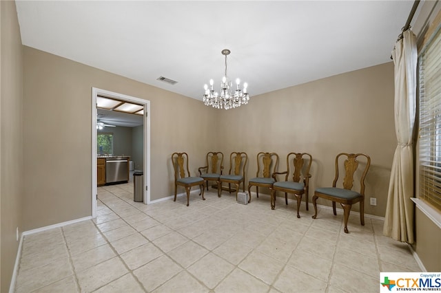 tiled dining area with ceiling fan with notable chandelier
