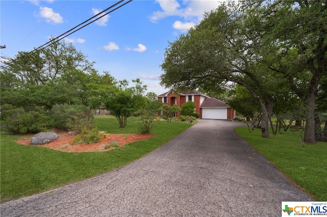 view of front of property featuring a garage and a front yard