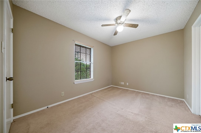 unfurnished room with ceiling fan, light colored carpet, and a textured ceiling