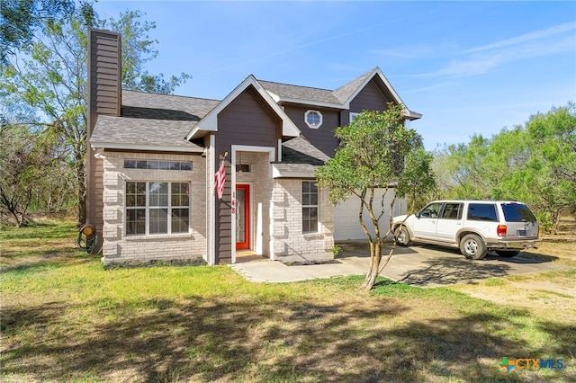 view of front of home with a front yard and a garage