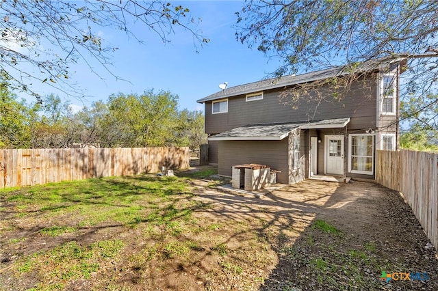 rear view of house featuring a yard