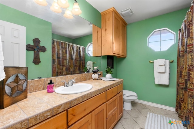 bathroom featuring tile patterned flooring, vanity, and toilet