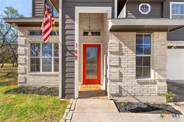 view of exterior entry featuring a garage