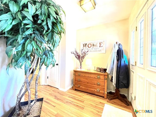 interior space with light wood finished floors and baseboards