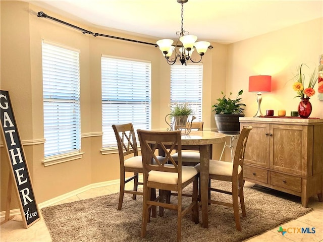 dining room featuring light tile patterned floors, baseboards, and a chandelier