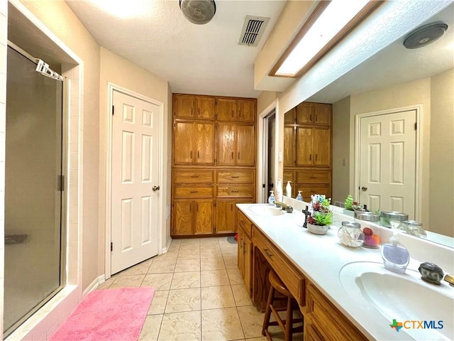 full bath featuring a sink, visible vents, and a stall shower