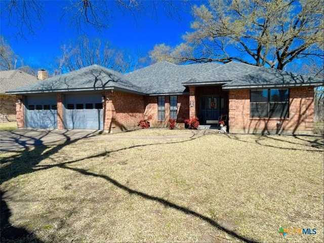 ranch-style home with driveway, brick siding, roof with shingles, and an attached garage