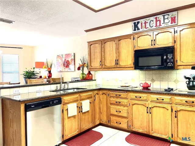 kitchen with visible vents, a peninsula, a sink, black appliances, and backsplash