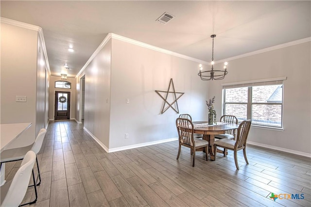 dining area with a notable chandelier and crown molding