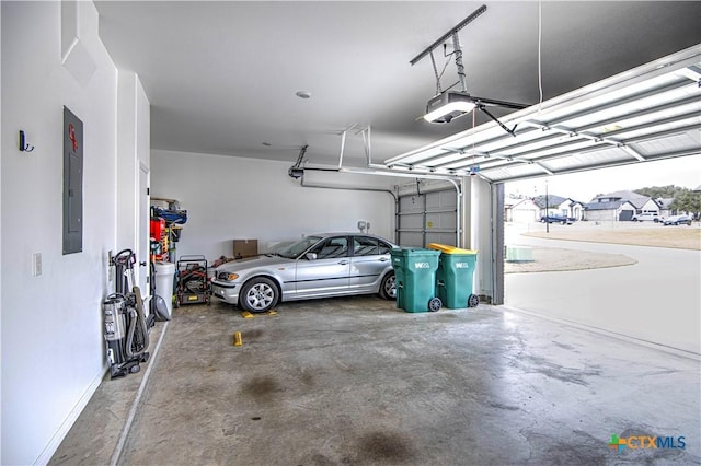 garage with a garage door opener and electric panel