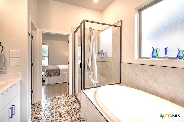 bathroom featuring tile patterned flooring, vanity, and independent shower and bath