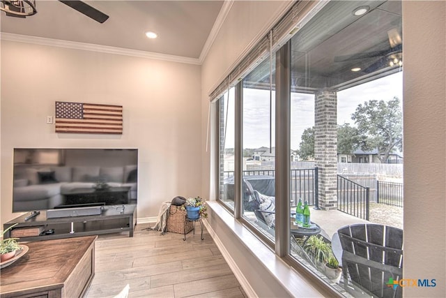 interior space featuring crown molding, ceiling fan, and light hardwood / wood-style flooring