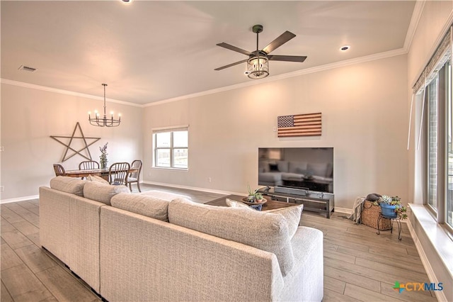 living room featuring ornamental molding, wood-type flooring, and ceiling fan with notable chandelier